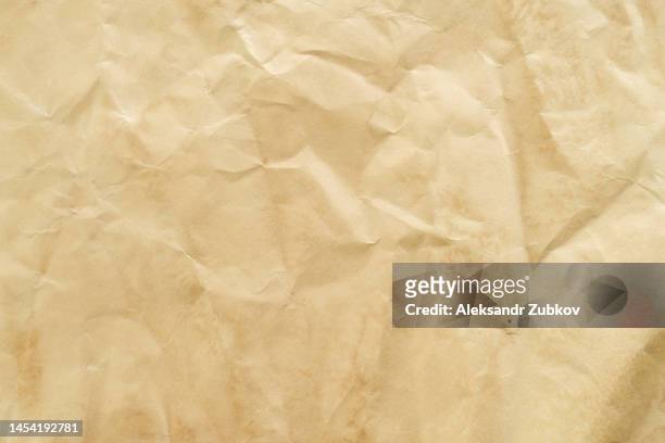 a texture made of recycled crumpled paper or a paper background for a design with a place to copy text. abstract background for advertising. secondary use of paper. - fond usé photos et images de collection