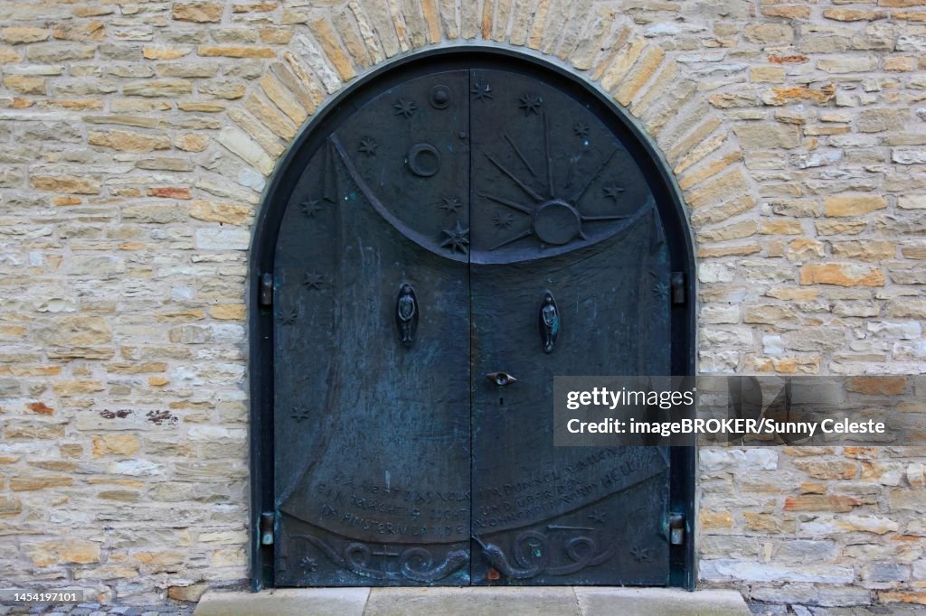 Entrance door with Adam and Eve, St. Boniface, a former free-world ladies' convent with a collegiate church in Freckenhorst, Warendorf district, North Rhine-Westphalia, Germany