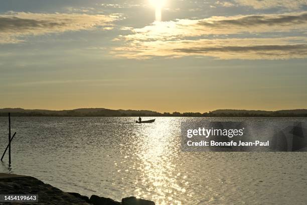 a fisherman’s boat in the rising sun - aude stock pictures, royalty-free photos & images