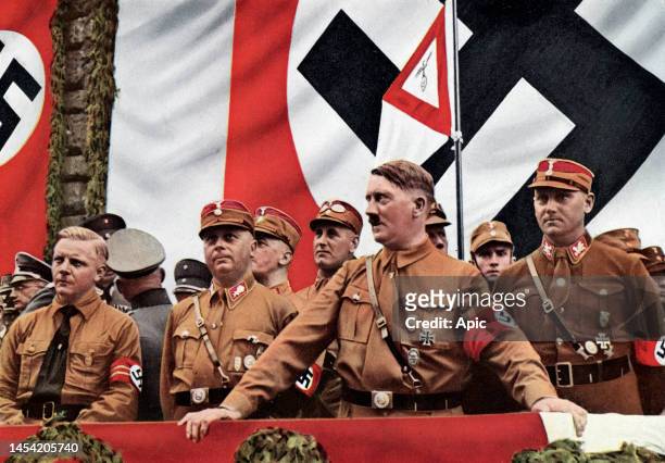 Adolf Hitler wearing SA uniform, in Dortmund with Josef Wagner, Wilhelm Echepman et Victor Luke for the parade of the SA, Section of Westphalia, on...