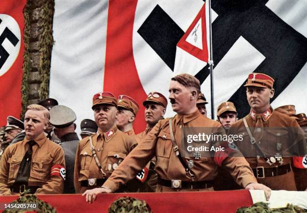 Adolf Hitler wearing SA uniform, in Dortmund with Josef Wagner, Wilhelm Echepman et Victor Luke for the parade of the SA, Section of Westphalia, on...