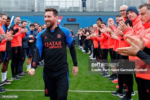 Leo Messi is congratulated by teammates and staff as he returns to a Paris Saint-Germain training after his World Cup title on January 04, 2023 in...