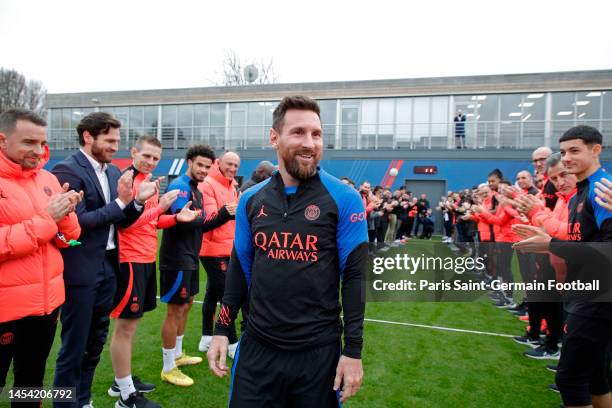 Leo Messi is congratulated by teammates and staff as he returns to a Paris Saint-Germain training after his World Cup title on January 04, 2023 in...