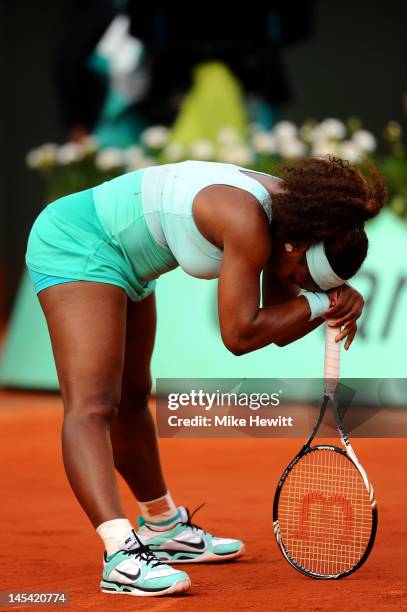 Serena Williams of USA shows her frustration as she rests her head on her racquet during her women's singles first round match between Serena...