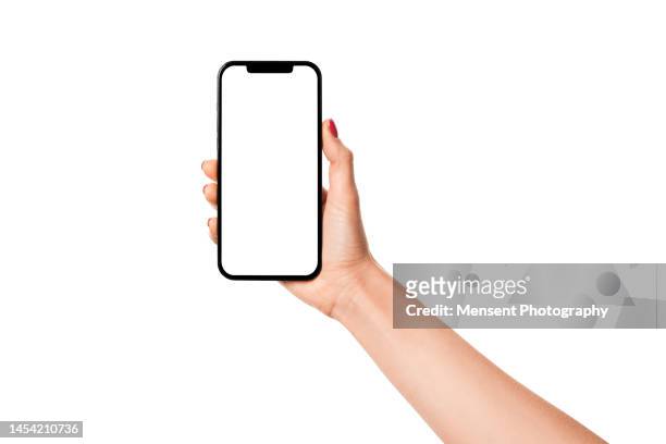 woman hand holding modern smartphone iphone mockup with white screen on white background - holding mobile phone stock-fotos und bilder
