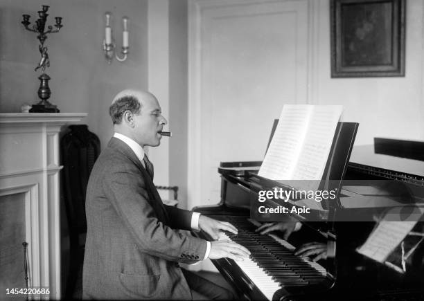 Pablo Casals spanish cellist, conductor here playing the piano and smoking a cigar, circa 1915.