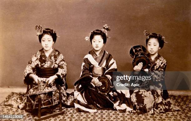Three japanese women Playing Drums. Albumen photograph by Schutamarko, c1880s.