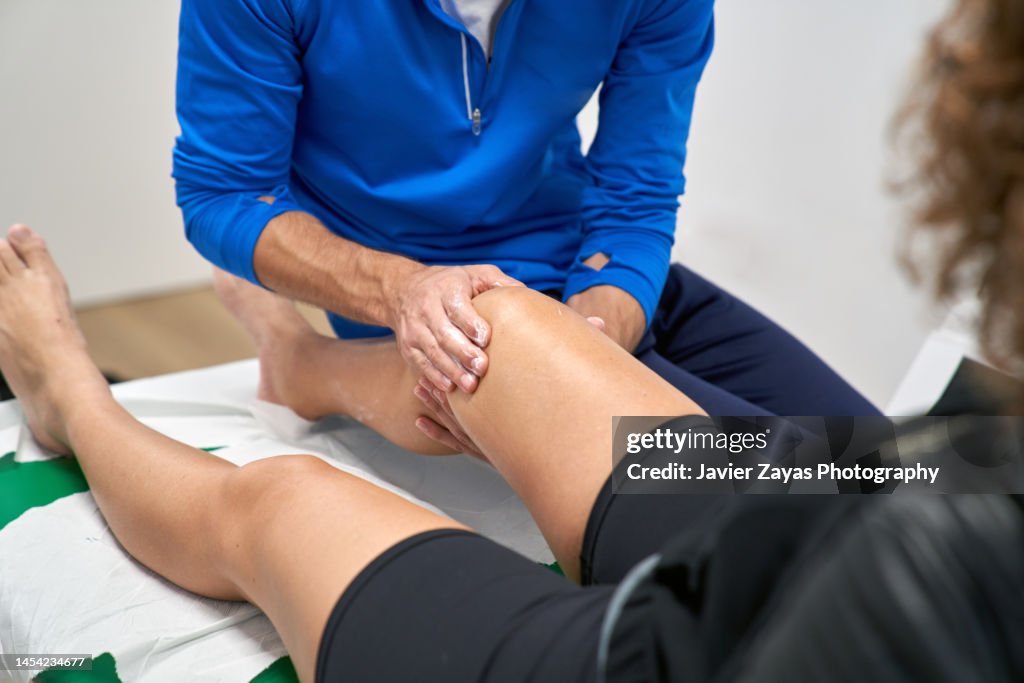 Physiotherapist Assisting In The Recovery Of A Woman's Knee After Meniscus Surgery