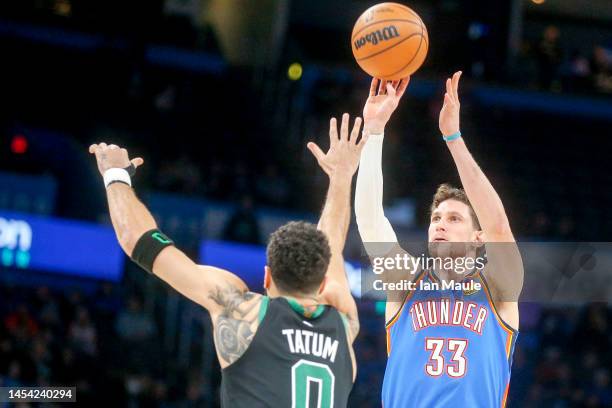 Mike Muscala of the Oklahoma City Thunder shoots over Jayson Tatum of the Boston Celtics during the first quarter at Paycom Center on January 03,...