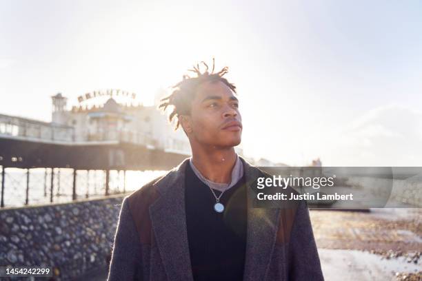 man looking away thinking in the low winter sunshine - beach no people stock pictures, royalty-free photos & images