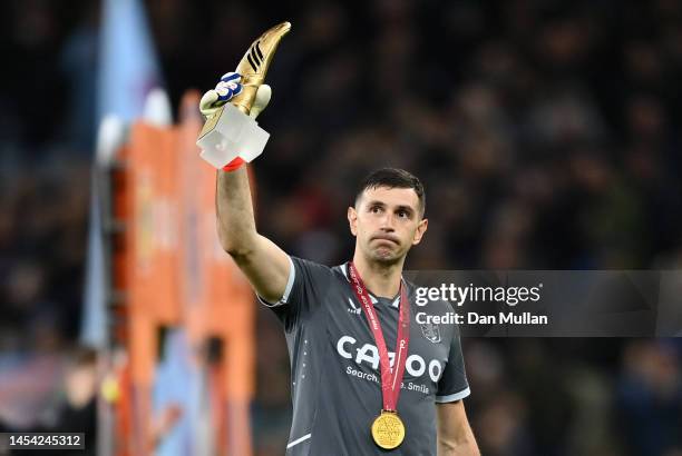 Emiliano Martinez of Aston Villa holds his adidas FIFA World Cup Golden Glove trophy while wearing his FIFA World Cup winners medal prior to the...