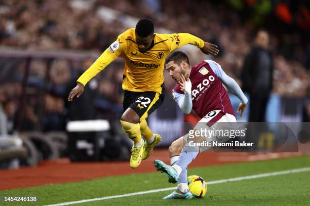 Emi Buendia of Aston Villa is put under pressure by Nelson Semedo of Wolverhampton Wanderers during the Premier League match between Aston Villa and...