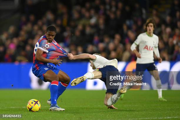 Oliver Skipp of Tottenham Hotspur pulls the shirt of Cheick Doucoure of Crystal Palace during the Premier League match between Crystal Palace and...