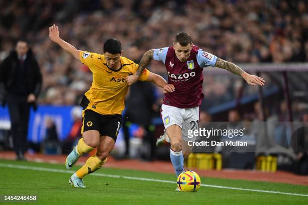Lucas Digne of Aston Villa battles for possession with Hwang Hee-chan of Wolverhampton Wanderers during the Premier League match between Aston Villa...