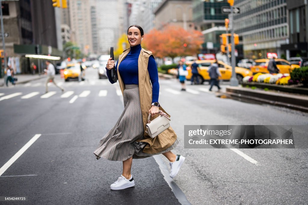A woman seen crossing the street in New York during a busy work day