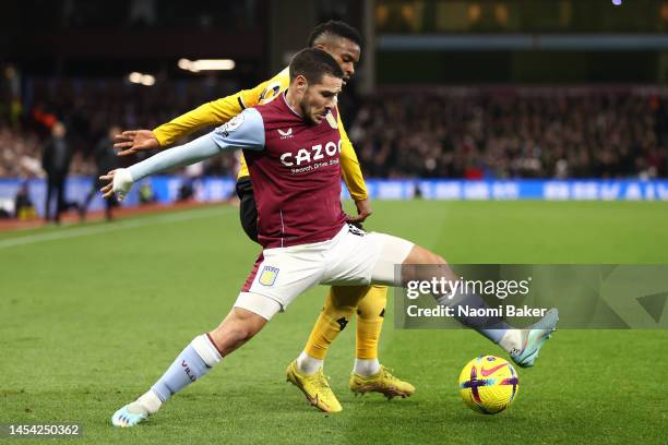 Emi Buendia of Aston Villa is challenged by Nelson Semedo of Wolverhampton Wanderers during the Premier League match between Aston Villa and...