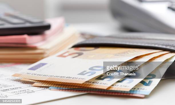 european union currency with calculator and financial theme - taxes stock-fotos und bilder