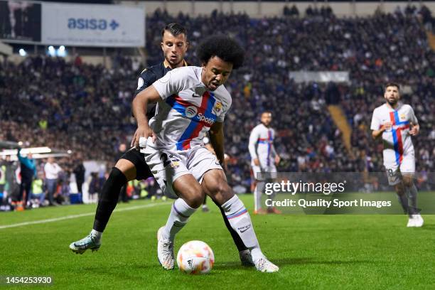 Pol Roige of Intercity competes for the ball with Jules Kounde of FC Barcelona during the Copa Del Rey Round of 32 match between Intercity and FC...