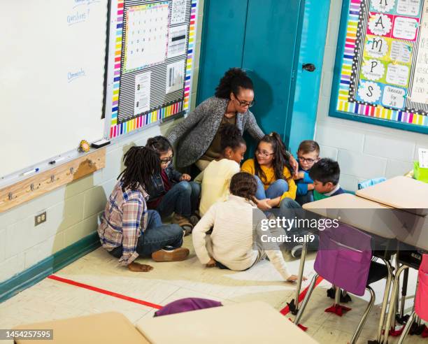 teacher and children doing school safety drill, lockdown - lockdown drill stock pictures, royalty-free photos & images