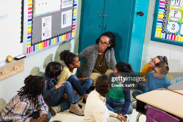 teacher and children doing school safety drill, lockdown - lockdown drill stock pictures, royalty-free photos & images