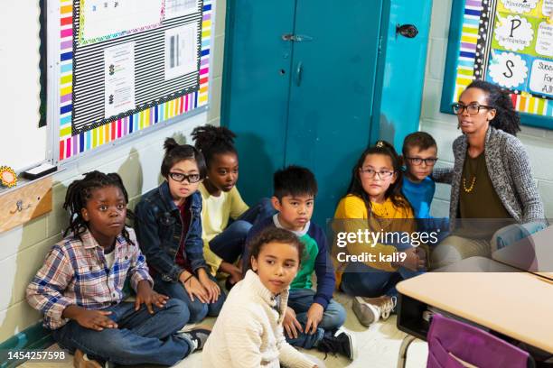 teacher and children doing school safety drill, lockdown - lockdown drill stock pictures, royalty-free photos & images