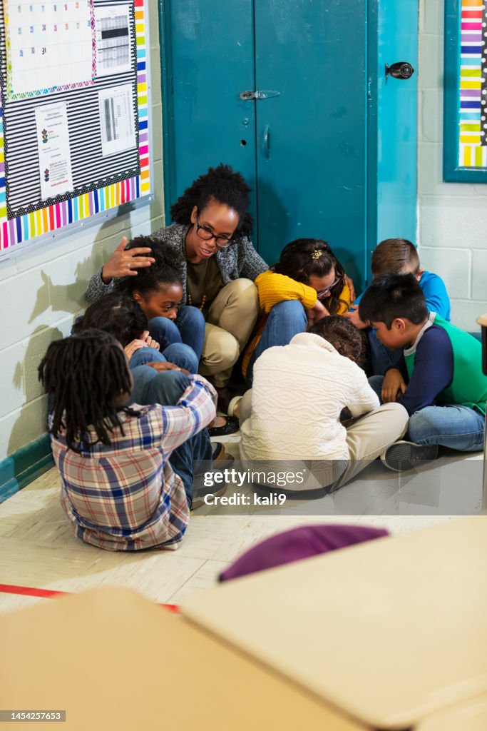 Teacher and children doing school safety drill, lockdown