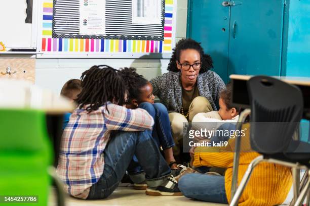 teacher and children doing school safety drill, lockdown - lockdown drill stock pictures, royalty-free photos & images