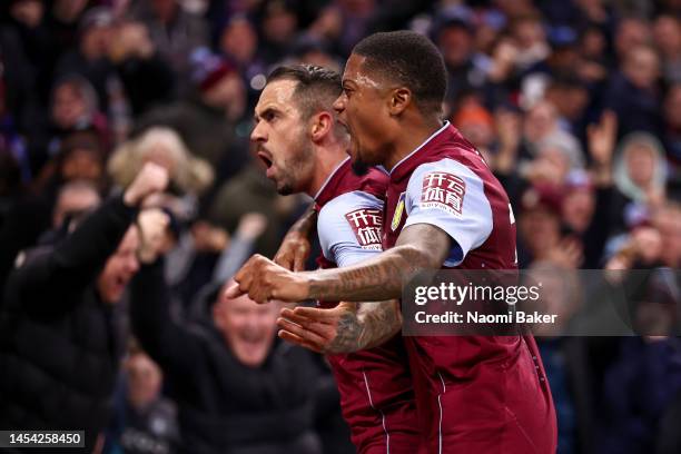 Danny Ings of Aston Villa celebrates with teammate Leon Bailey after scoring the team's first goal during the Premier League match between Aston...