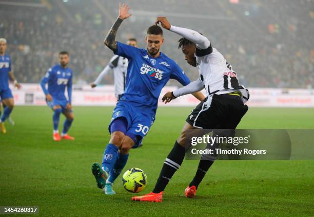 Destiny Udogie of Udinese Calcio competes for the ball with Petar Stojanovic of Empoli FC during the Serie A match between Udinese Calcio and Empoli...
