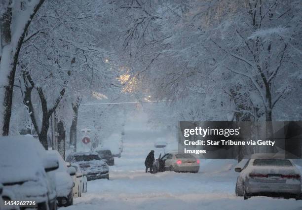 Motorist tries to dig out a stuck car on a south Minneapolis street Wednesday, Jan. 4, 2023 in Minneapolis, Minn. The Twin Cities has received about...