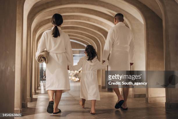 family in luxury hotel - robe stock pictures, royalty-free photos & images
