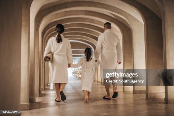 family in luxury hotel - bathrobe stock pictures, royalty-free photos & images