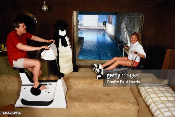 Thorne and Trish Donnelly work out in the gym of their luxury Aspen home August 23, 1987 in Aspen, Colorado