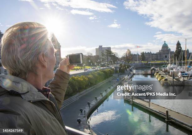 mature man takes photo of marina and skyline - ottawa skyline stock pictures, royalty-free photos & images