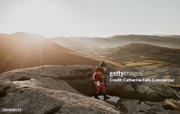 a little girl explores a mountain ridge - kids hiking stock pictures, royalty-free photos & images