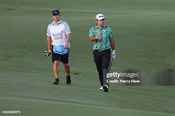 Hideki Matsuyama of Japan and caddie Shota Hayafuji walk the tenth fairway during the pro-am prior to the Sentry Tournament of Champions at...