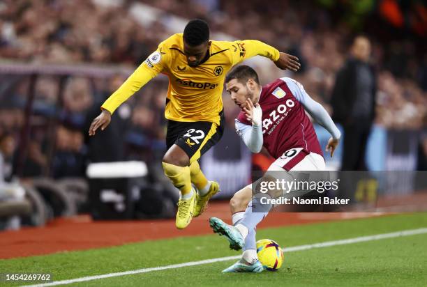 Emi Buendia of Aston Villa is put under pressure by Nelson Semedo of Wolverhampton Wanderers during the Premier League match between Aston Villa and...