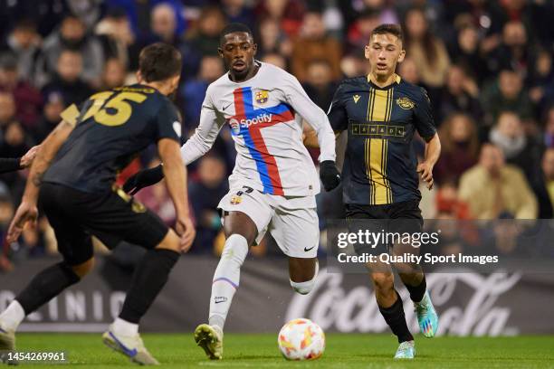 Alvaro Perez of CF Intercity competes for the ball with Ousmane Dembele of FC Barcelona during the Copa Del Rey round of 32 match between CF...