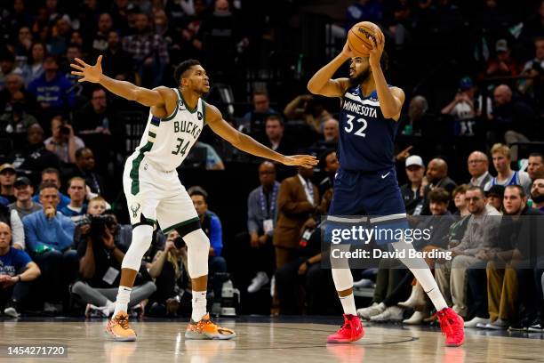 Karl-Anthony Towns of the Minnesota Timberwolves competes while Giannis Antetokounmpo of the Milwaukee Bucks defends in the third quarter of the game...