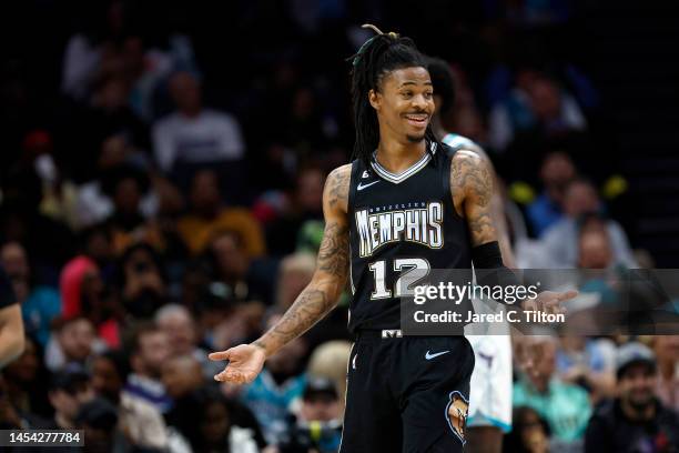 Ja Morant of the Memphis Grizzlies reacts following a basket during the first quarter of the game against the Charlotte Hornets at Spectrum Center on...