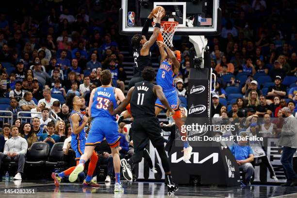 Paolo Banchero of the Orlando Magic dunks the ball as Shai Gilgeous-Alexander of the Oklahoma City Thunder defends during the first quarter at Amway...