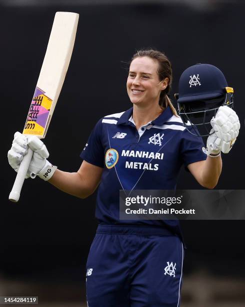 Ellyse Perry of Victoria raises her bat after making a century during the WNCL match between Victoria and New South Wales at CitiPower Centre, on...