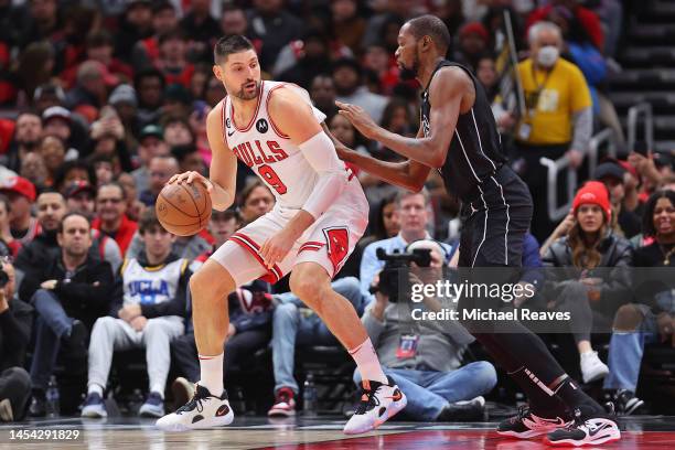 Nikola Vucevic of the Chicago Bulls drives to the basket against Kevin Durant of the Brooklyn Nets during the first half at United Center on January...
