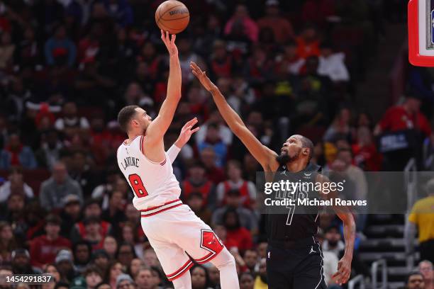 Zach LaVine of the Chicago Bulls shoots over Kevin Durant of the Brooklyn Nets during the first half at United Center on January 04, 2023 in Chicago,...