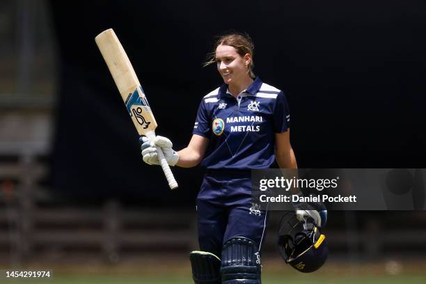 Nicole Faltum of Victoria raises her bat after making a century during the WNCL match between Victoria and New South Wales at CitiPower Centre, on...