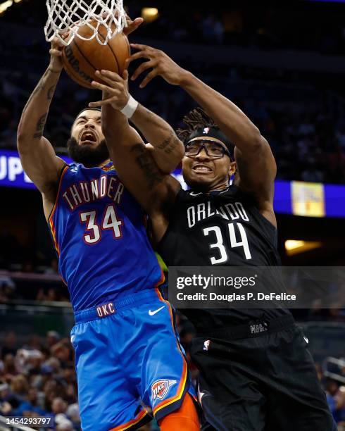 Kenrich Williams of the Oklahoma City Thunder and Wendell Carter Jr. #34 of the Orlando Magic fight for the ball during the third quarter at Amway...