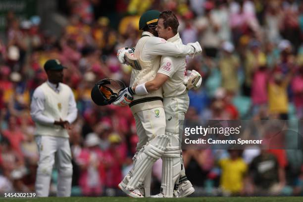 Steve Smith of Australia celebrates his century with Usman Khawaja of Australia during day two of the Second Test match in the series between...