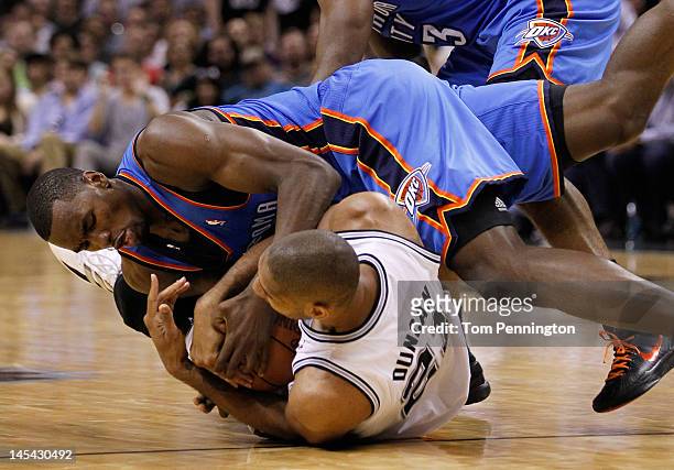 Serge Ibaka of the Oklahoma City Thunder and Tim Duncan of the San Antonio Spurs battle for the ball on the floor in the second quarter in Game Two...