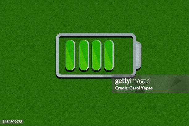 green battery charging - battery charging stock pictures, royalty-free photos & images