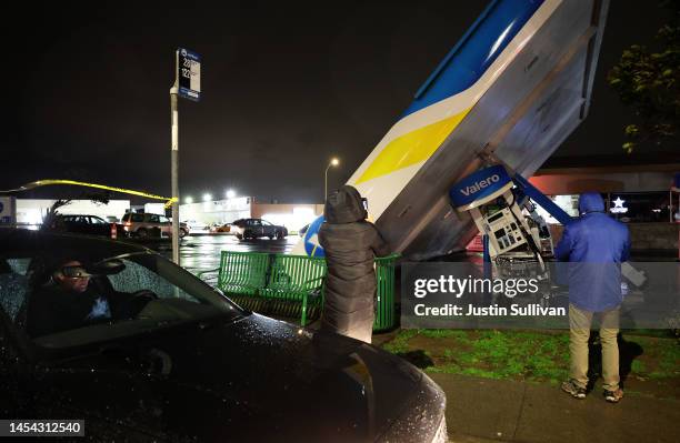 The canopy at a Valero gas station rests on the ground after being toppled by high winds on January 04, 2023 in South San Francisco, California. Gov....